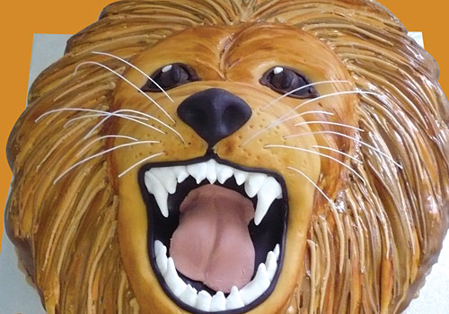 A birthday cake shaped like a lion